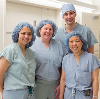 From left: Nita Lee, MD, assistant professor of Obstetrics/Gynecology; Meaghan Tenney, MD, assistant professor of Obstetrics/Gynecology; Ernst Lengyel, MD, PhD, chairman, Department of Obstetrics/Gynecology; and Diane Yamada, MD, chief, Section of Gynecologic Oncology; outside the operating room in the Center for Care and Discovery 