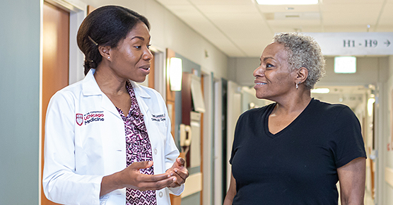 Gynecologist Sandra Laveaux, MD, speaking with a patient