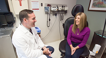 Gynecologic oncologist John Moroney, MD, consults with a patient