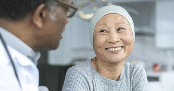 Asian female cancer patient with male doctor