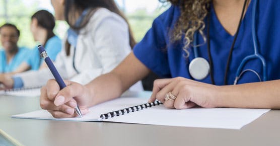 Nurses or other clinicians in an education environment, taking notes