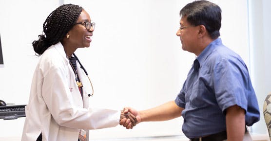 Olatoyosi Odenike, MD, shaking hands with patient