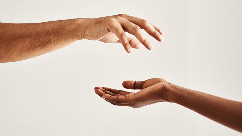 Two hands reaching out to each other