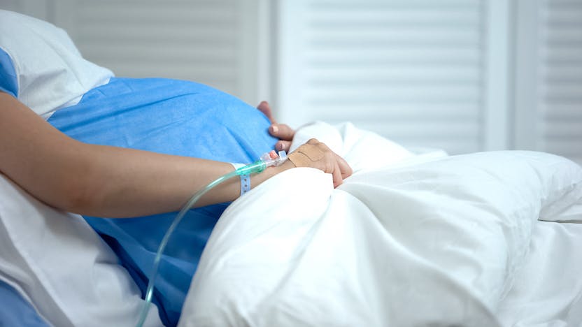 Close up of pregnant person in hospital bed