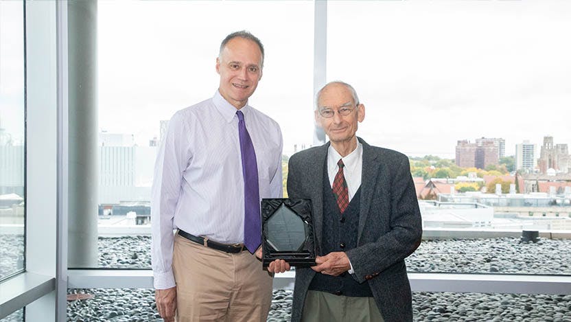 Michael R. Bishop, MD, presents the David Jonas Memorial Award to Hans Schreiber, MD, PhD.
