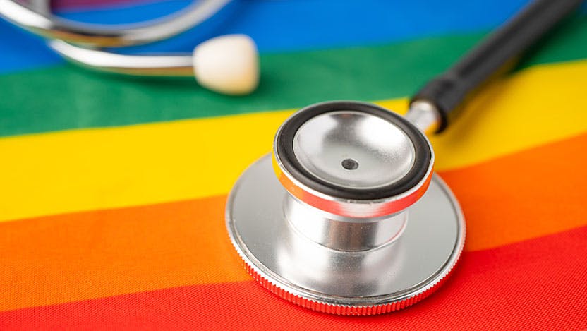 Black stethoscope on rainbow flag background