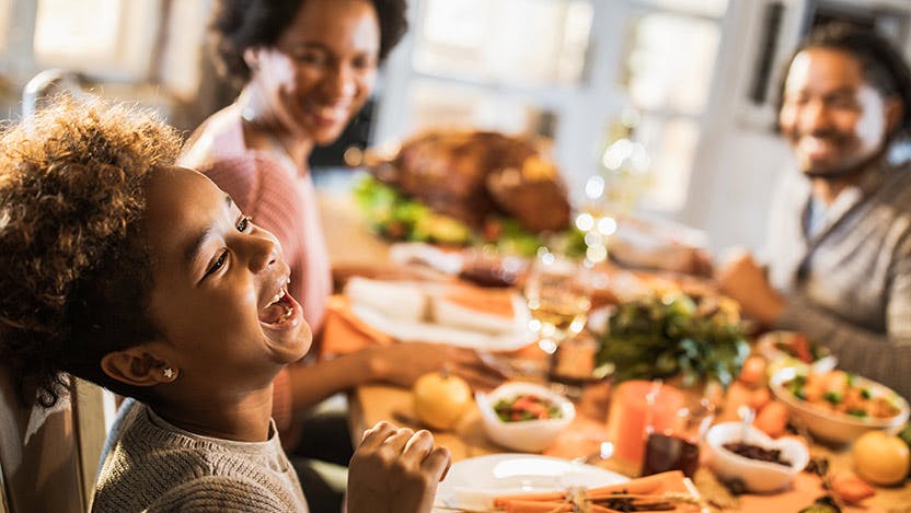 A child with celiac disease eating a holiday meal with family