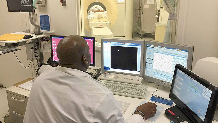 Radiology CT technologist Mike Mason prepares a patient for a virtual colonoscopy procedure
