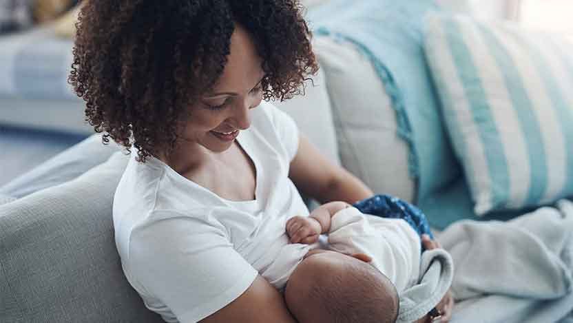 Black mom breastfeeding infant