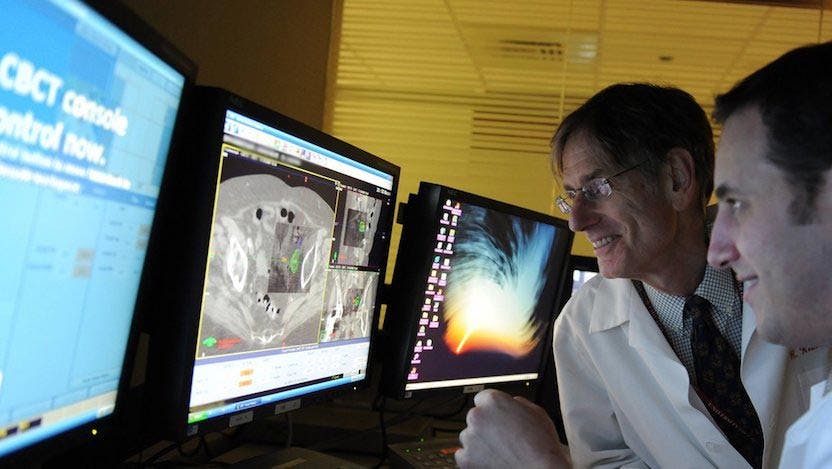 Ralph Weichselbaum, MD, looking at computer screens