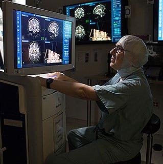 Neurosurgeon Peter Warnke, MD, reviews brain imaging