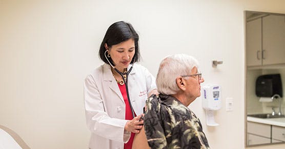 Helen Te, MD, Medical Director of the Adult Liver Transplant Program, with a patient
